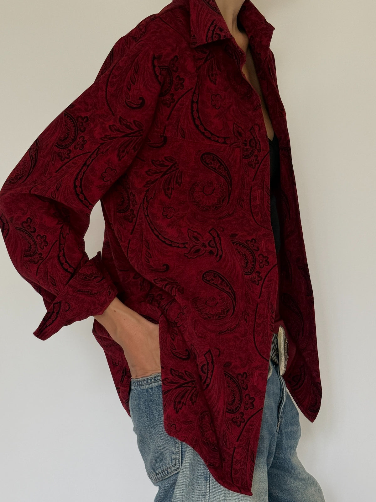 Vintage burgundy paisley shirt fabric and pattern close-up