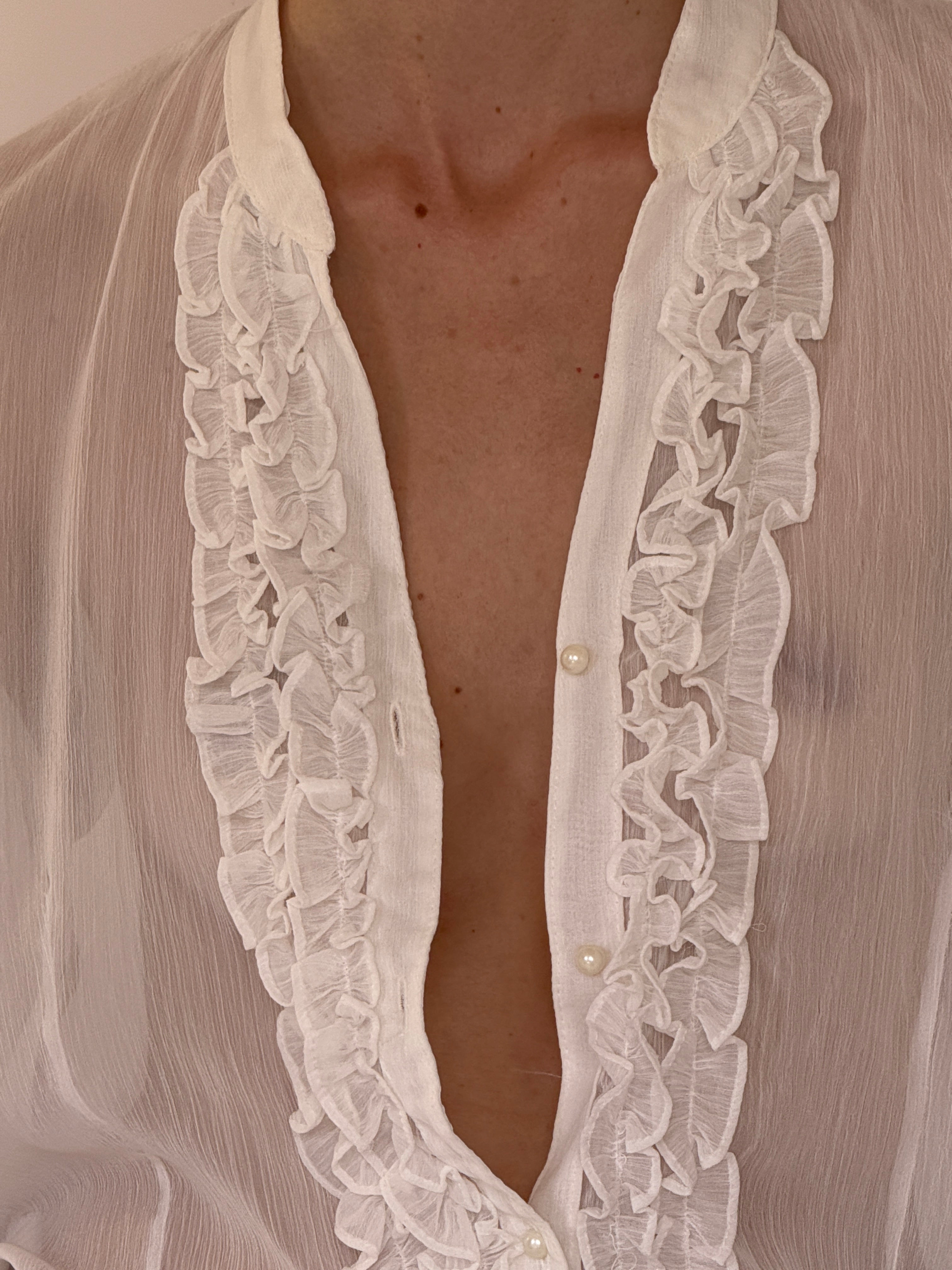 Vintage sheer white blouse close-up of ruffle trim