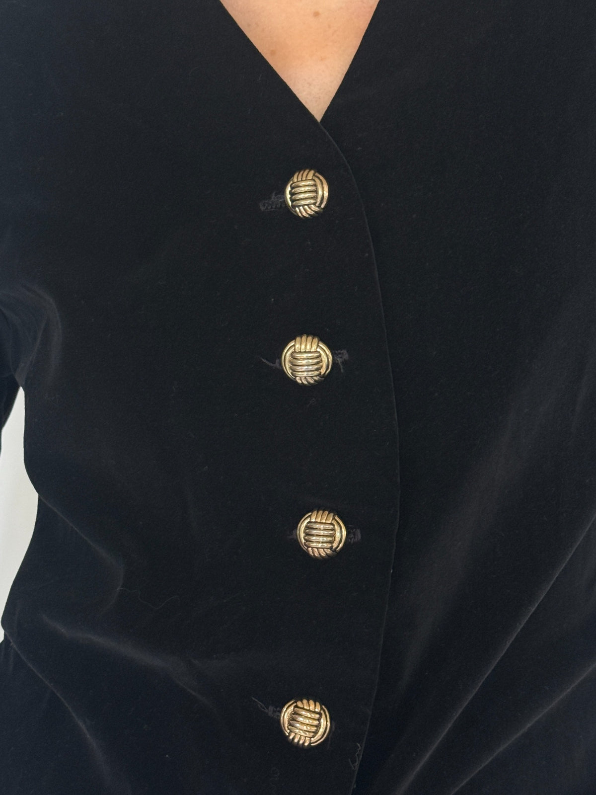 Vintage black velvet blazer gold button close-up