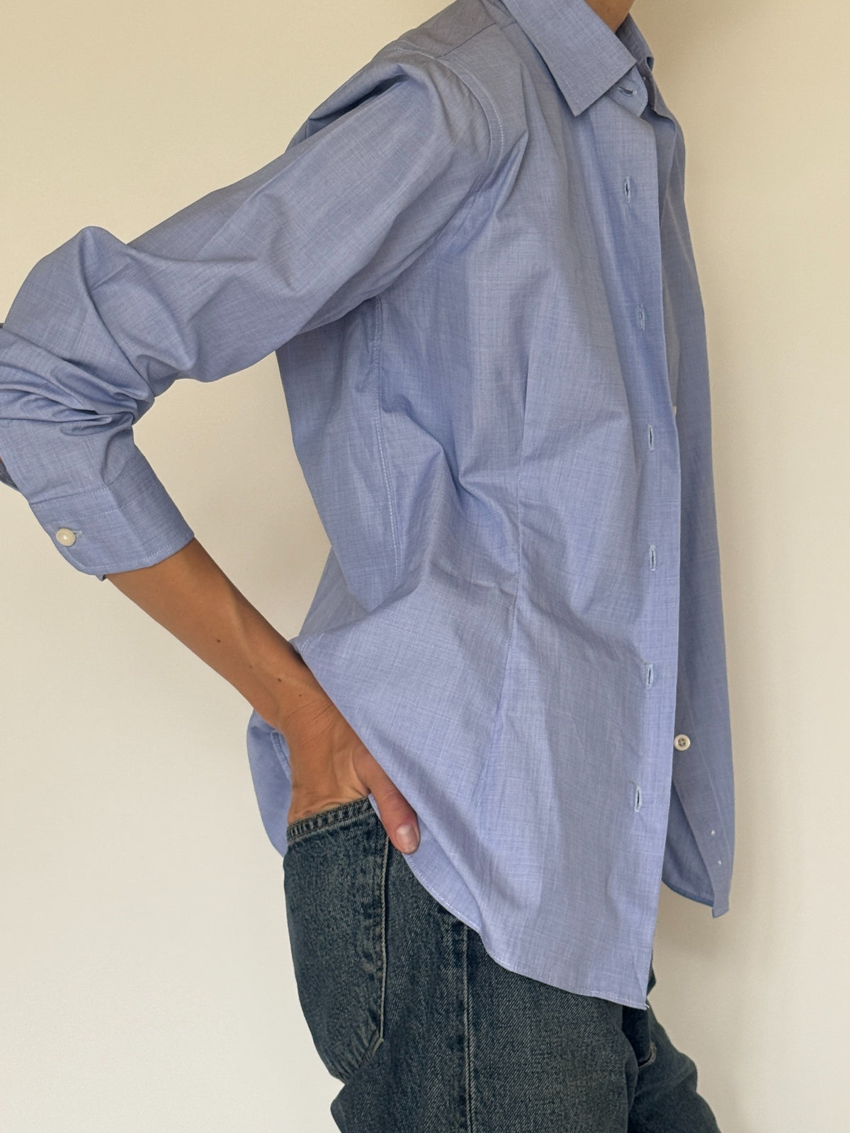 Side view of fitted light blue button-up shirt