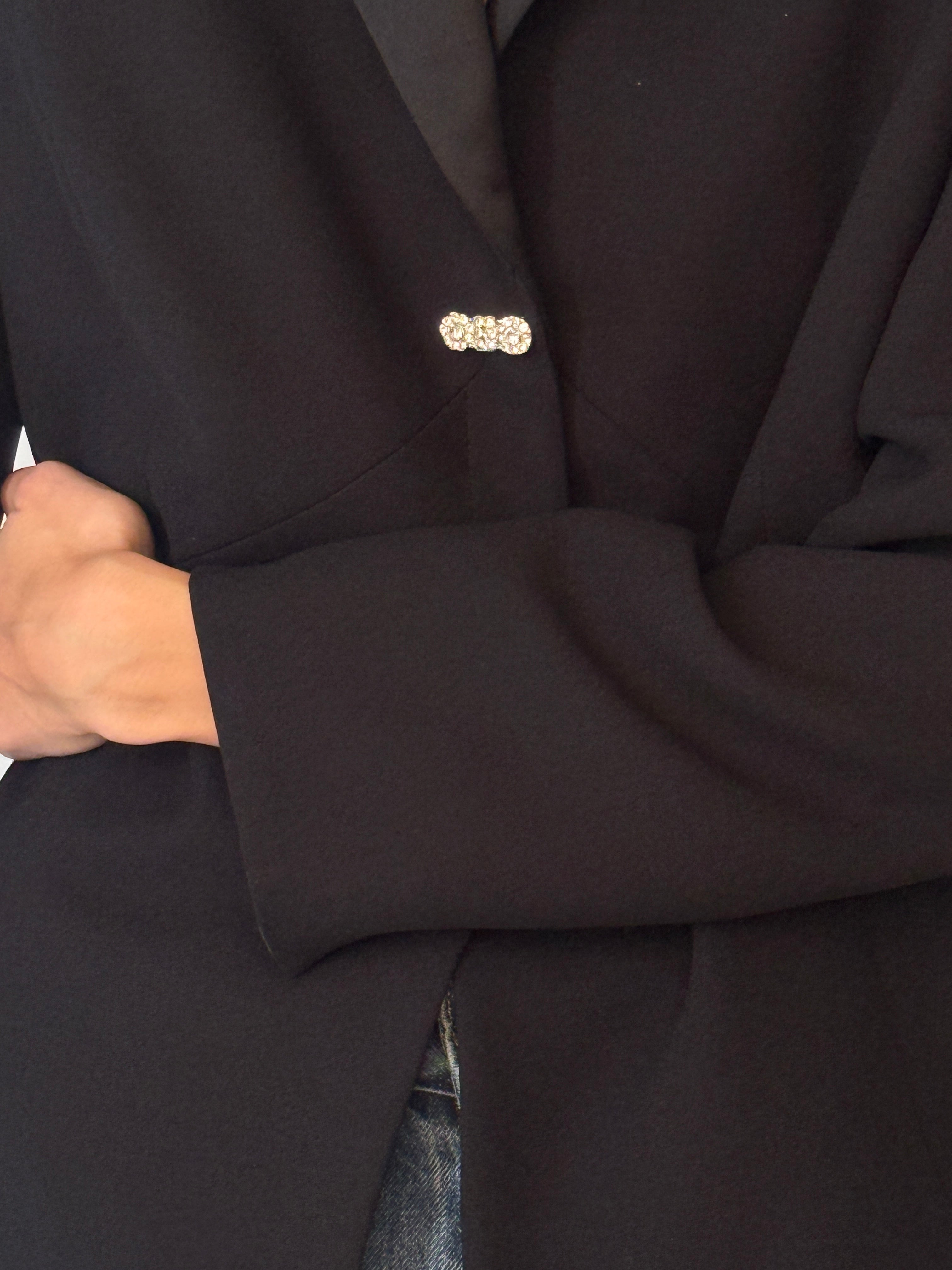 Vintage black embellished blazer fabric close-up