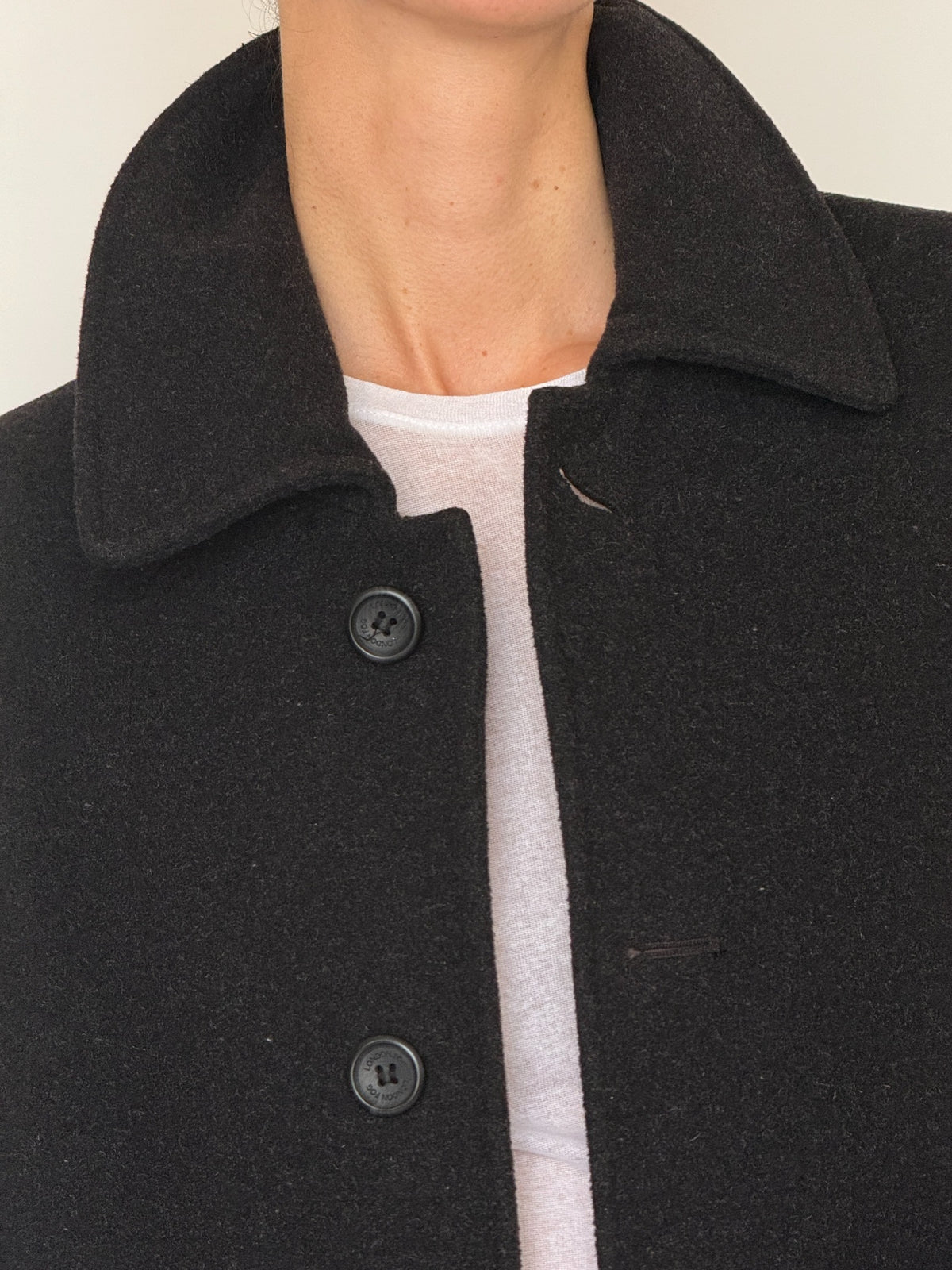 Vintage black wool blend coat button and collar detail