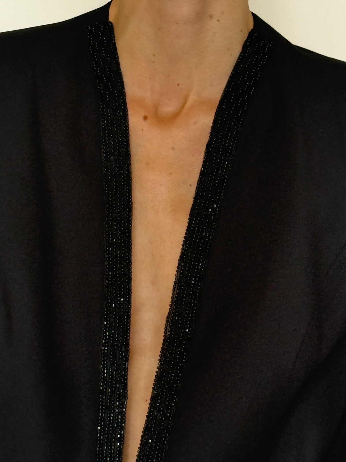 Vintage black blazer beaded neckline close-up