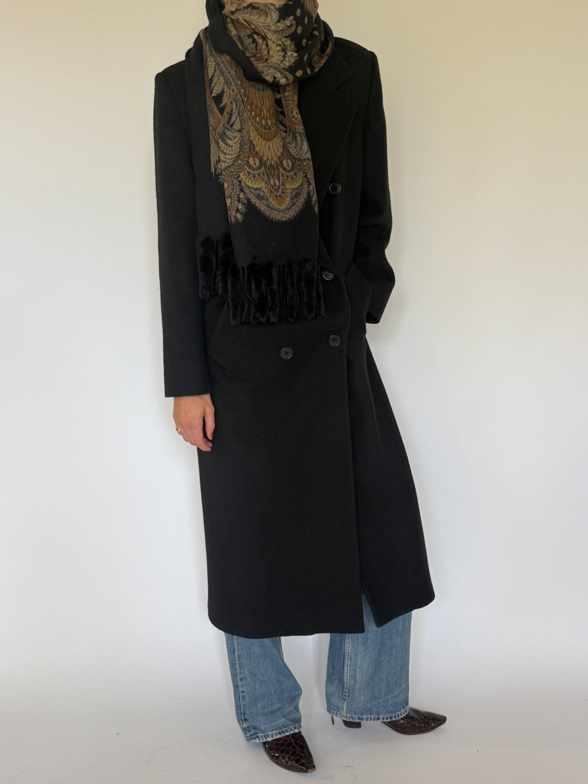Vintage black wool long coat styled angle with scarf
