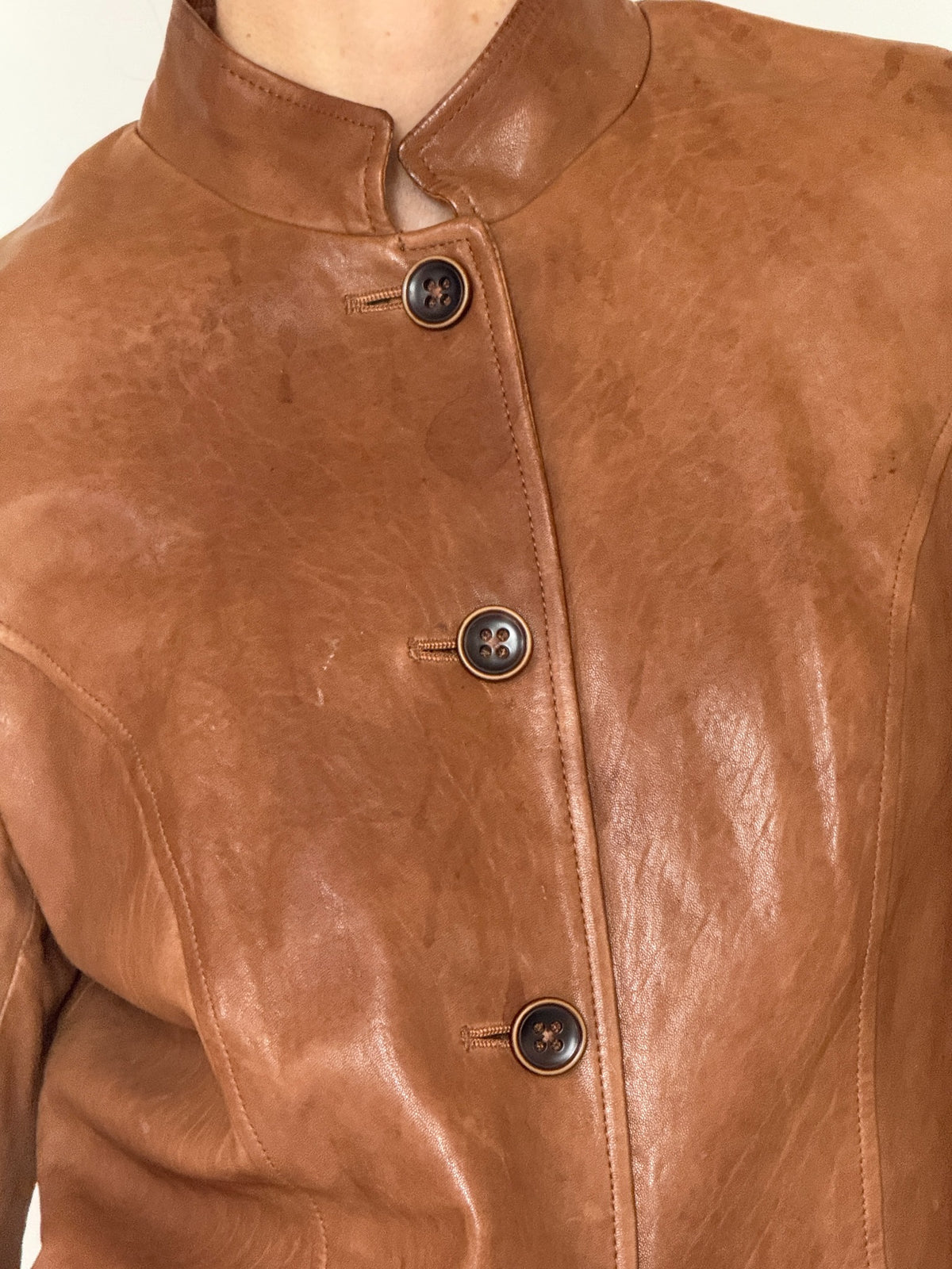 Vintage cognac leather jacket button and stand collar detail