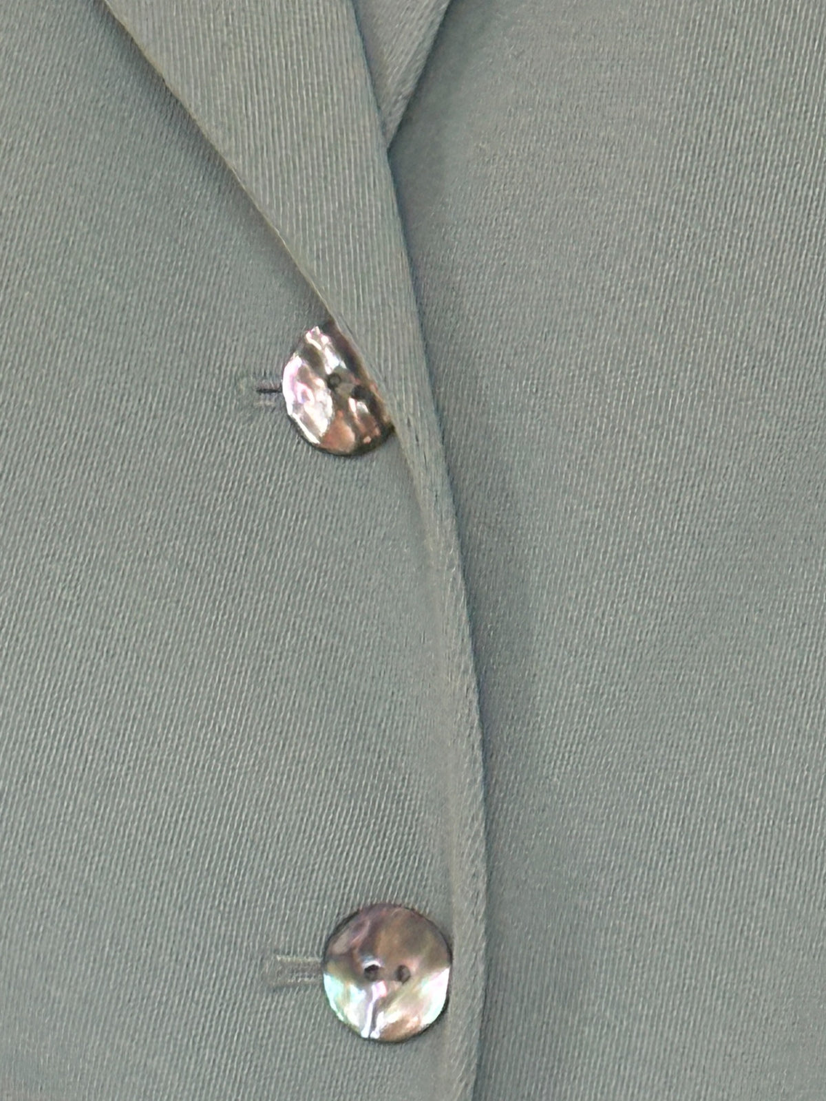 Vintage faded mint blazer button and welt pocket detail
