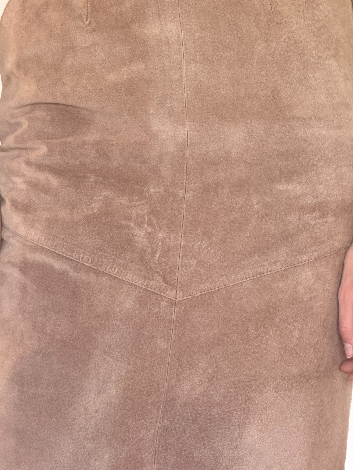 Vintage suede midi skirt fabric close-up showing soft taupe brown suede and panel seams