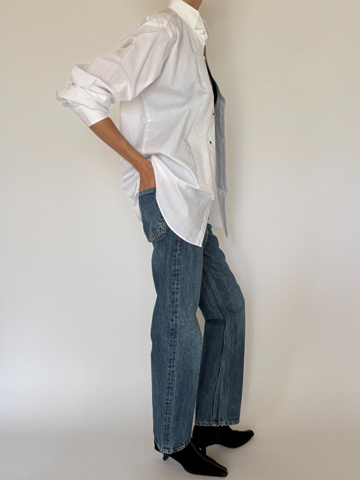 Vintage white tuxedo shirt side view with curved hem